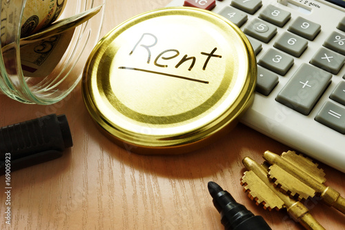 Pay rent concept. Jar with money for payment. photo