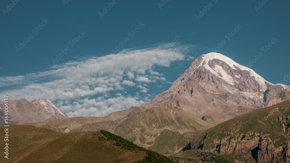 Mount Kazbek view from Stepantsminda town in Georgia in good weather for climbing. It is a dormant stratovolcano and one of the major mountains of the Caucasus.