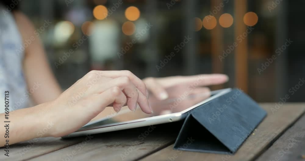 Woman using tablet computer at cafe
