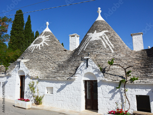 Traditional trulli houses with symbol on roofs, Alberobello, Italy