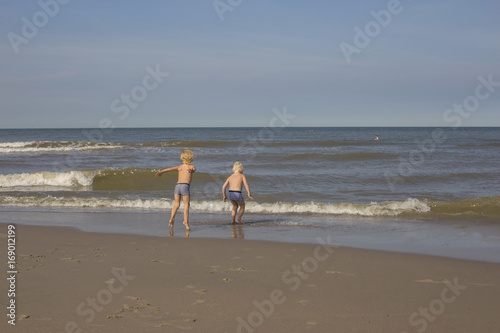 Children playing at the seashore photo