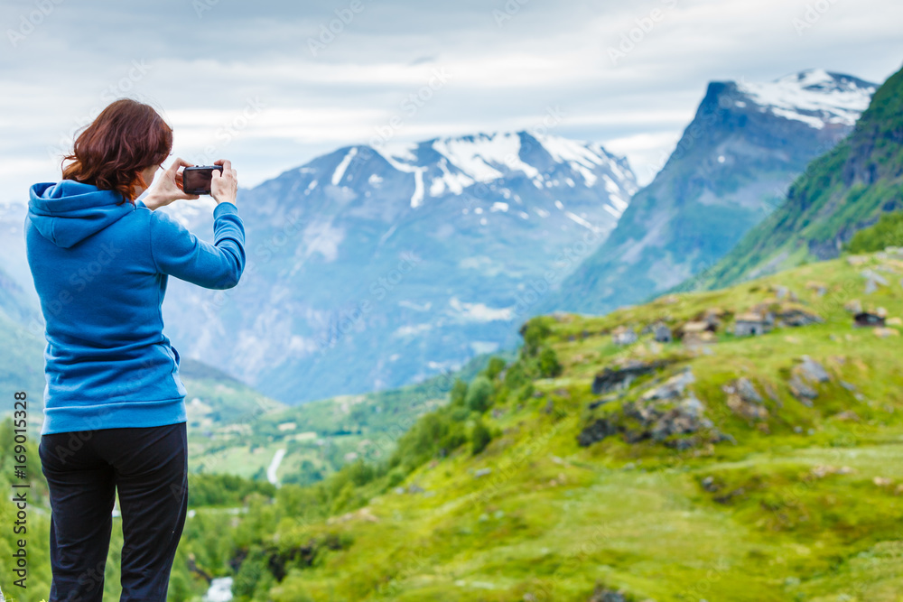 Tourist taking photo in mountains Norway
