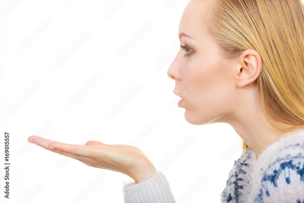 Blonde womn sending air kiss on palm hand Blonde womn sending air kiss on palm hand