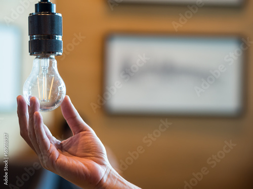 фотографія Man hand holding light blub