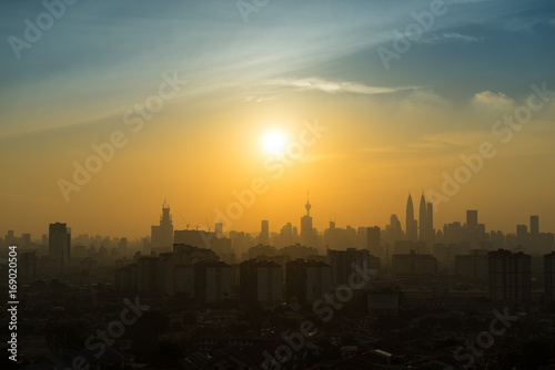 Majestic sunset over Petronas Twin Towers and surrounded buildings in downtown Kuala Lumpur  Malaysia 