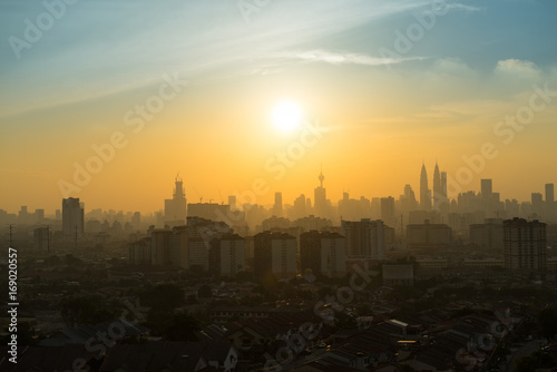 Canvas Print Majestic sunset over Petronas Twin Towers and surrounded buildings in downtown K