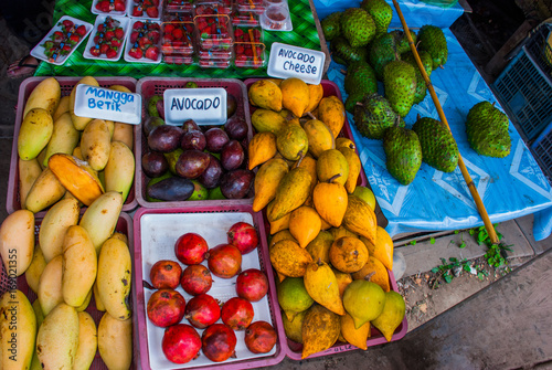 The traditional Asian market with food. Sale a variety of fruits lying on the counter. Malaysia photo