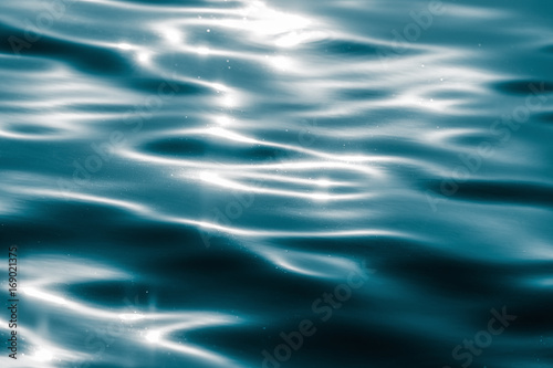 Fototapeta Naklejka Na Ścianę i Meble -  Water surface with moving wave of blue water reflecting light