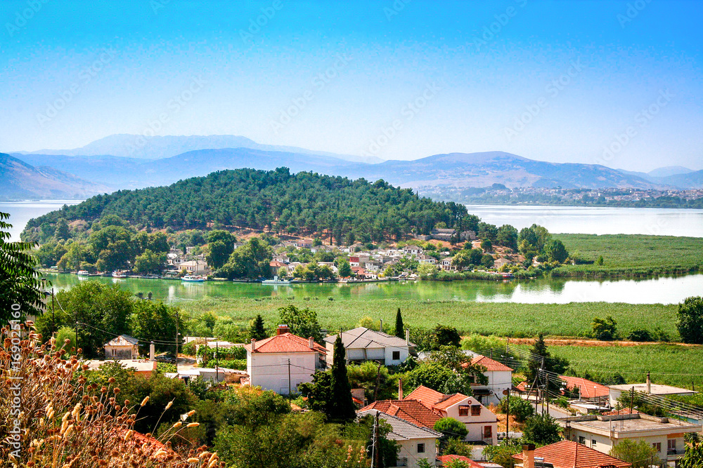 Obraz premium Houses with view to the lake Pamvotis and small island located in Ioannina. Greece
