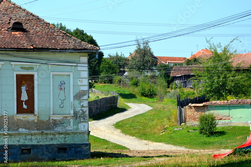 Storks. Typical rural landscape and peasant houses in  the village Somartin, Märtelsberg, Transylvania, Romania. The settlement was founded by the Saxon colonists in the middle of the 12th century photo