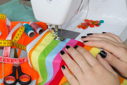 processes of sewing on the sewing machine sew women's hands sewing machine. women tailor threading leather material on sewing machine