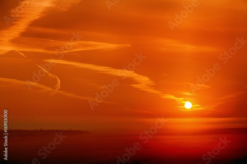 Fototapeta Naklejka Na Ścianę i Meble -  Red sunrise over the morning mist over the meadow