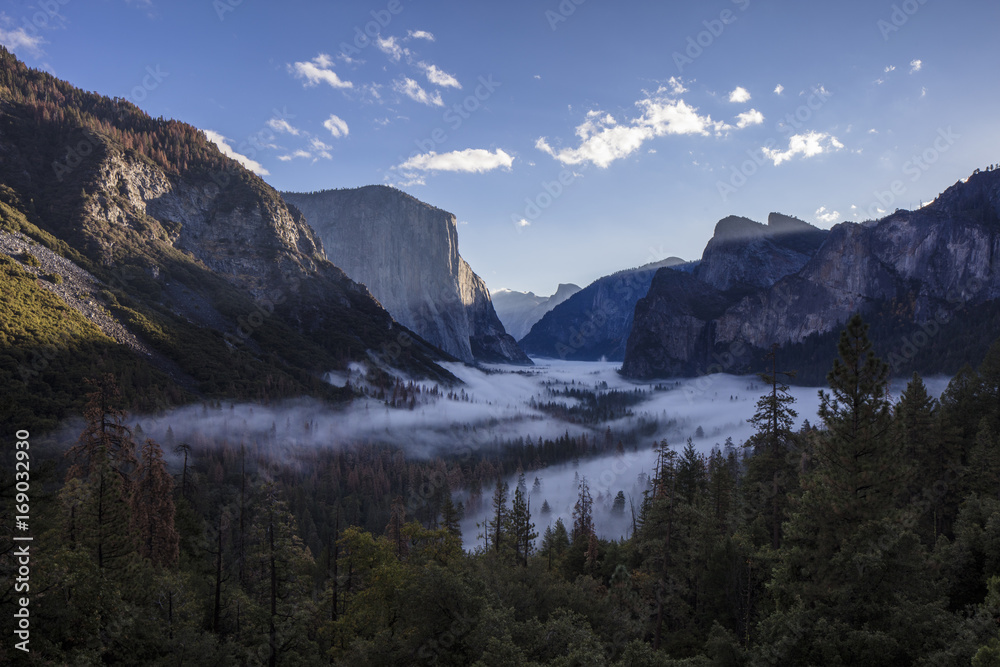 The view of the Yosemite Valley from the tunnel entrance to the Valley at sunrise. Yosemite National Park, California The view of the Yosemite Valley from the tunnel entrance to the Valley at sunrise. Yosemite National Park, California