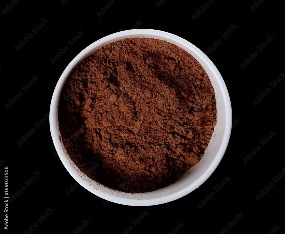 pile cocoa powder in bowl isolated on white background pile cocoa powder in bowl isolated on white background