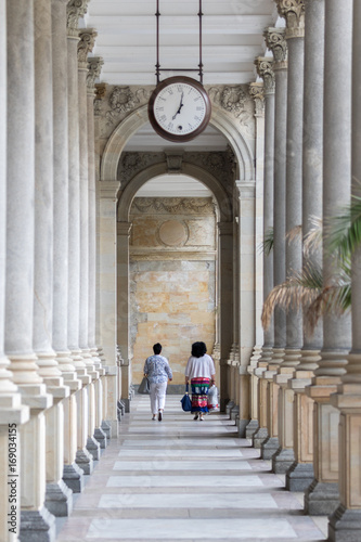 Karlovy Vary, Czech Republic - August 15, 2017:Ancient wall clock hanging near the city's spa colonnade