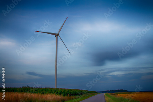 Windmills, power stations, cloudy skies and fields