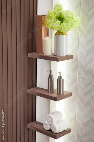 Metal liquid soap bottleon wooden shelf and Towels Bathroom accessories.
