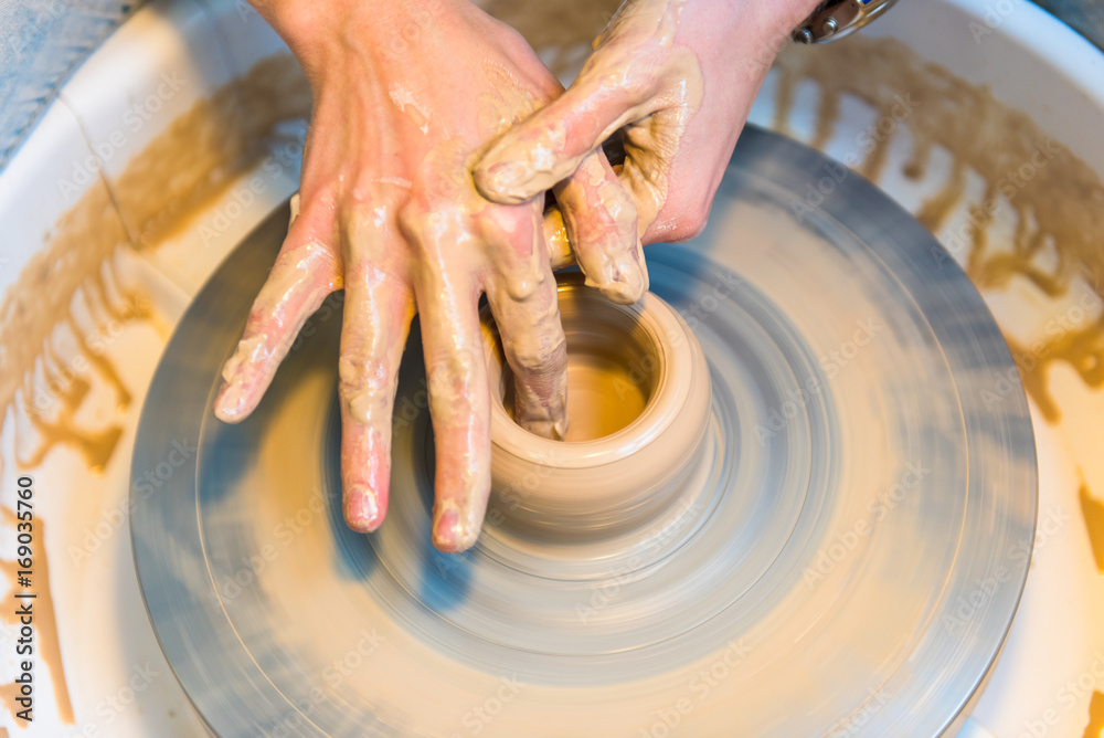Fototapeta premium Pottering - creating a clay cup in process