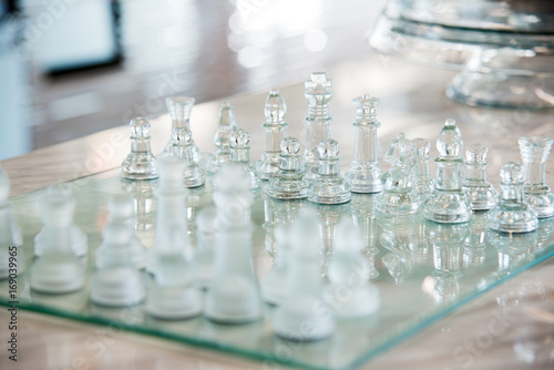 transparent glass chess board on the table