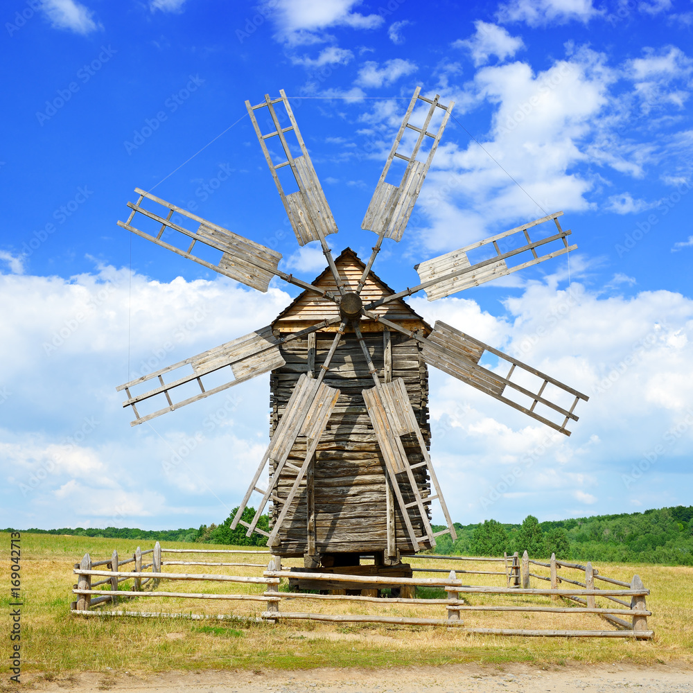 Fototapeta premium Old wooden windmill against the sky.