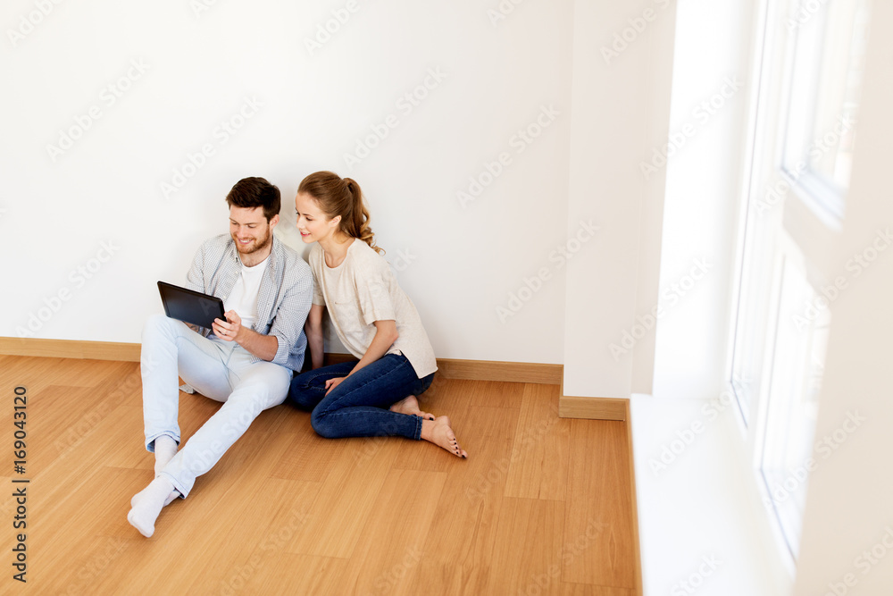 happy couple with tablet pc computer at new home happy couple with tablet pc computer at new home