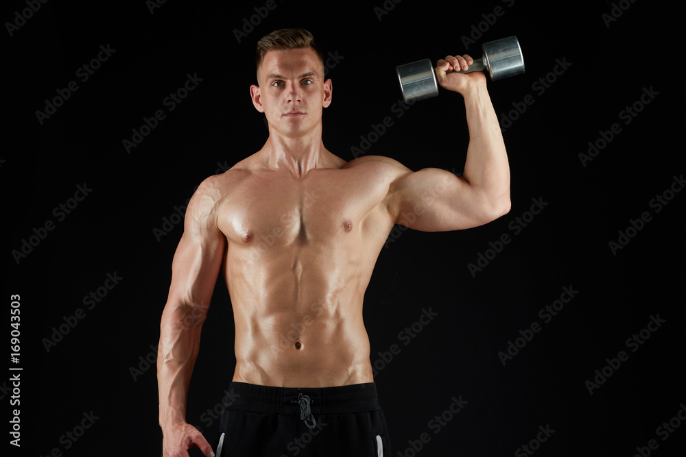 man with dumbbell exercising over black background man with dumbbell exercising over black background