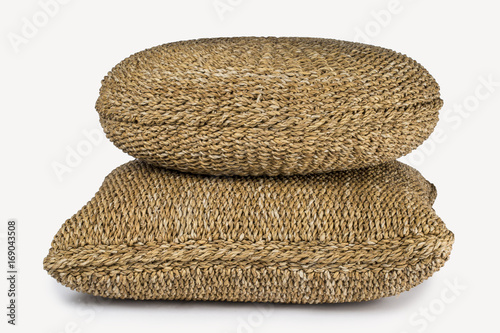 SET OF TWO LARGE RECTANGULAR AND ROUND NATURAL PLANT FIBRE BRAIDED DECORATIVE CUSHION POUF ON WHITE BACKGROUND photo