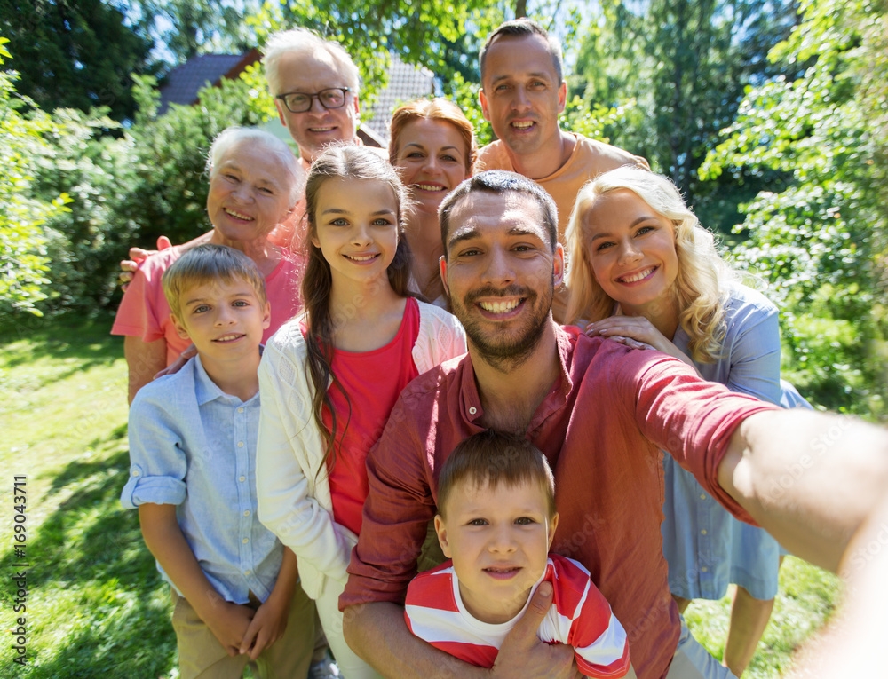 Fototapeta premium happy family taking selfie in summer garden