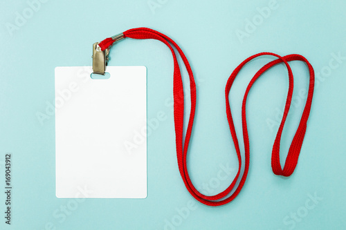 Blank security tag with red neck band on blue background. Space for text, mockup.