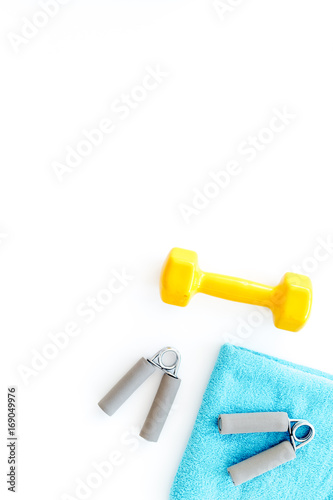 Equipment for fitness. Dumbbells and expander on white background top view copyspace