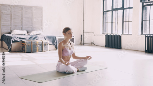 Beautiful yoga girl doing asanas in studio photo