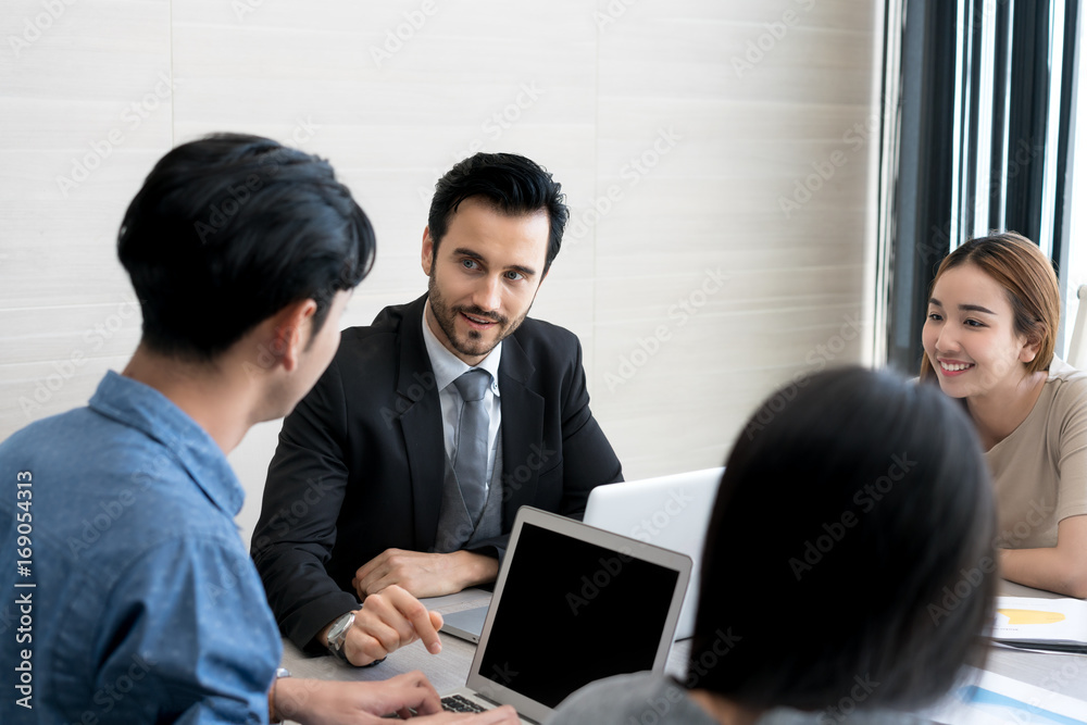 Group of multi-ethnic business partners discussing ideas in meeting room at office. Business people meeting corporate communication teamwork concept. Group of multi-ethnic business partners discussing ideas in meeting room at office. Business people meeting corporate communication teamwork concept.