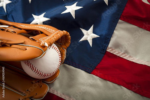 American sports and college athletics concept with the USA flag in the background and macro on a vintage baseball glove holding a ball with copy space