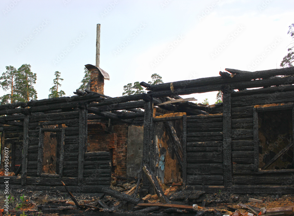 War destroyed, burned down wooden house, charred walls, burnt roof, black ceilings