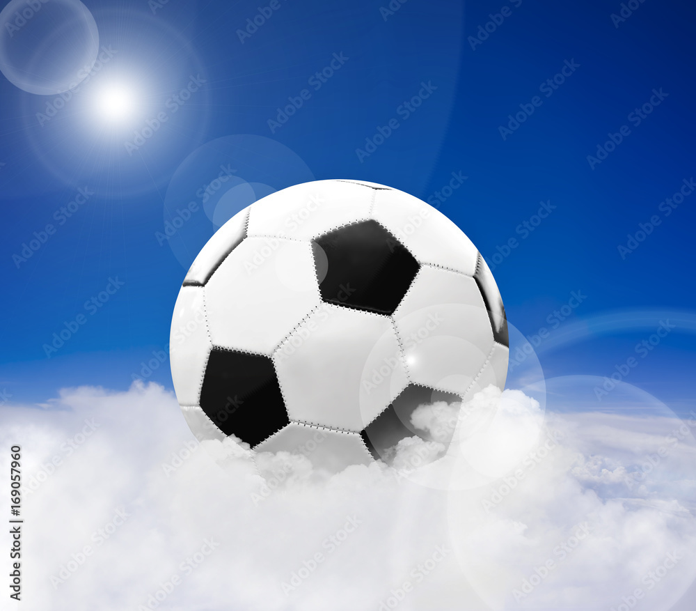 Soccer ball over clouds against blue sky