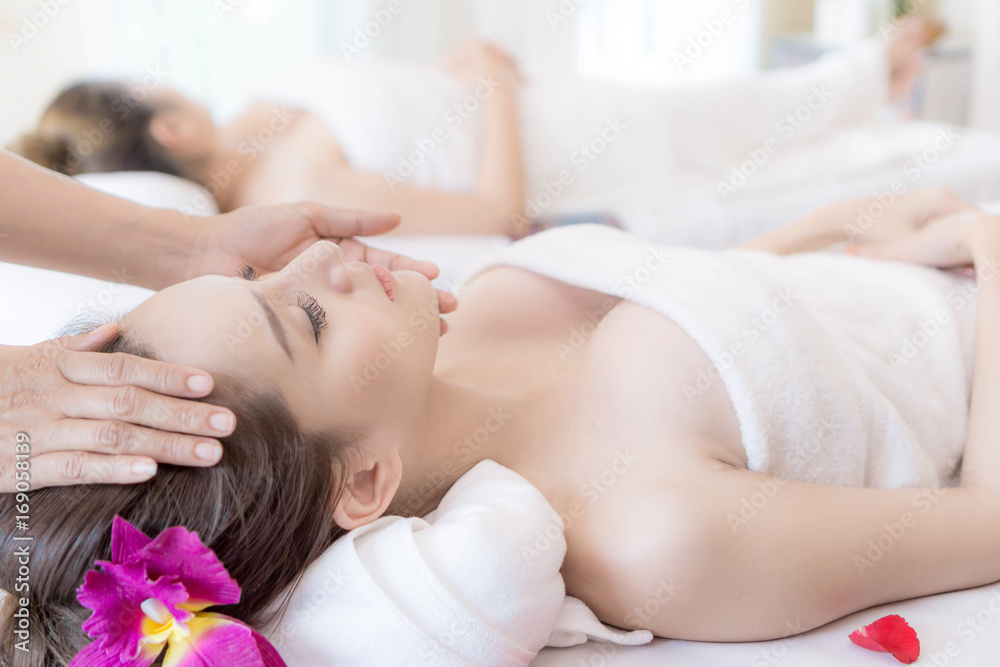beautiful and healthy young woman relaxing with face massage at beauty spa salon beautiful and healthy young woman relaxing with face massage at beauty spa salon