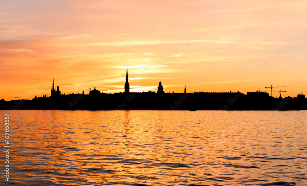 Skyline of the old town in Stockholm as a silhouette during sunset.