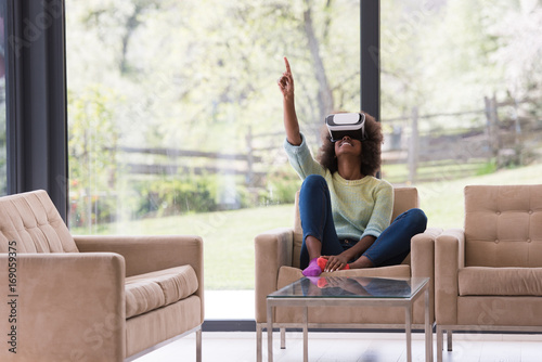 black woman using VR headset glasses of virtual reality