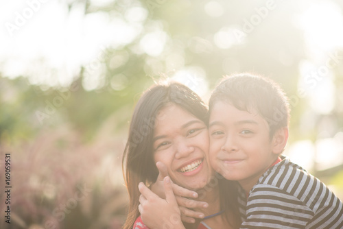 Single mom walking with son together with happy face