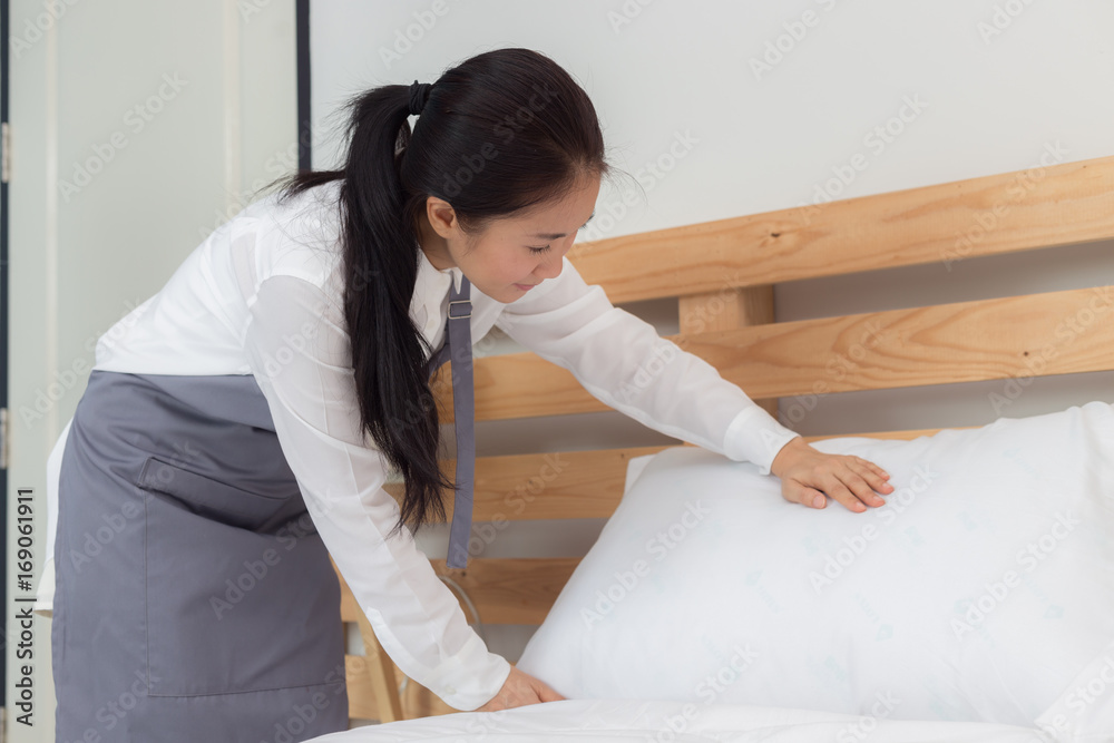 Beautiful asian maid cleaning blanket in bedroom Beautiful asian maid cleaning blanket in bedroom