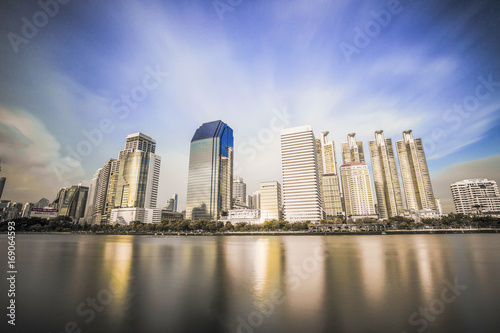 beautiful Bangkok city view from Benjakitti Park with water reflection © Phongphakkan