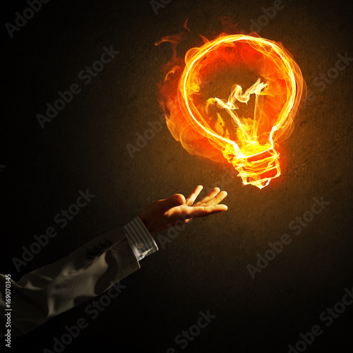 Concept of electricity or inspiration with burning light bulb