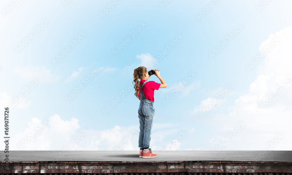 Concept of careless happy childhood with girl of school age looking in future Concept of careless happy childhood with girl of school age looking in future