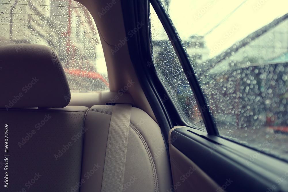 back seat inside vehicle car with rain drop on window