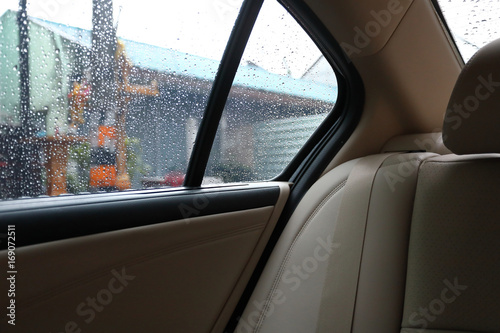 back seat inside vehicle car with rain drop on window