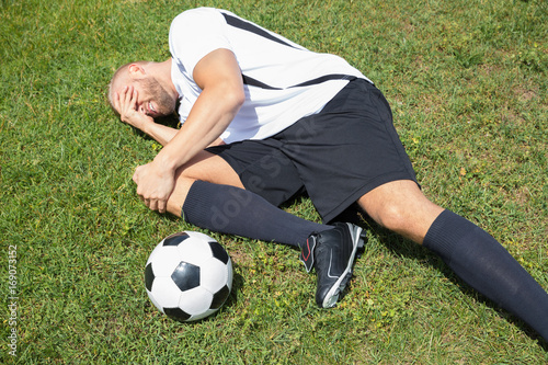 Male Soccer Player Suffering From Knee Injury