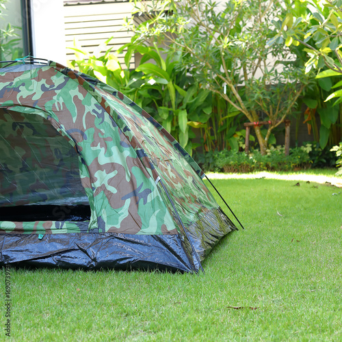 tent camping on green grass field campground, equipment for trip backpack