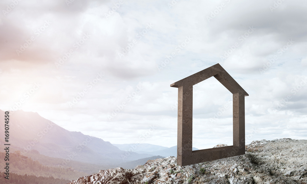 Conceptual image of concrete home sign on hill and natural landscape at background Conceptual image of concrete home sign on hill and natural landscape at background