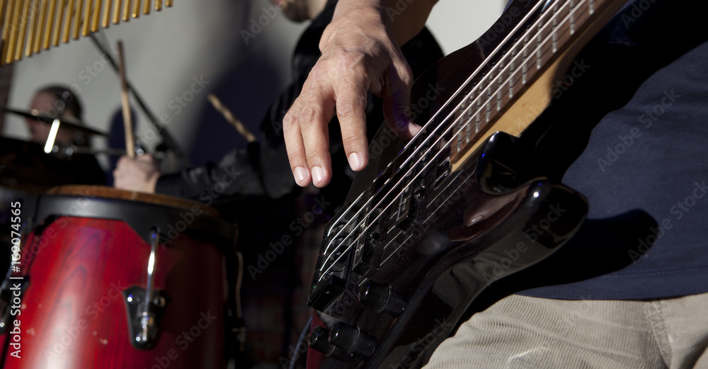 Fototapeta premium Bass guitar in hands of musician
