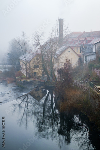 Old factory Sesir in Skofja Loka in fog. photo